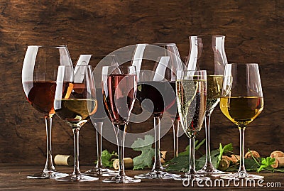 Wine tasting, still and sparkling wines. Red, white wine, rose and champagne ÑˆÑ‚ assortment in wine glasses on vintage wooden Stock Photo